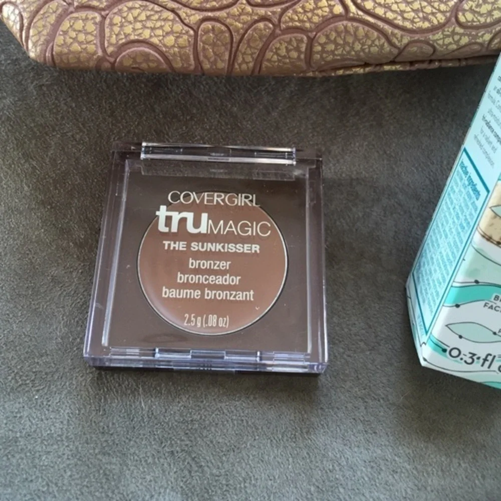 Makeup bag, sunscreen and Cover Girl bronzer